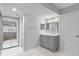 Bathroom vanity with grey cabinetry, white countertop, and chrome fixtures at 19505 Quesada Ave # Jj102, Port Charlotte, FL 33948