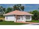 Cozy brick home with a charming pergola and a well-maintained lawn at 20208 Winkler Ave, Port Charlotte, FL 33954