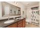 Bathroom featuring a double sink vanity, large mirror, and tub with shower at 2132 Nuremberg Blvd, Punta Gorda, FL 33983