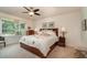 Bright main bedroom with a ceiling fan, a large window, and a king-sized bed at 2132 Nuremberg Blvd, Punta Gorda, FL 33983