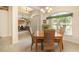 Open dining room with wood table, wicker chairs, chandelier, and plenty of natural light at 2132 Nuremberg Blvd, Punta Gorda, FL 33983
