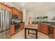 The kitchen shows wood cabinets, stainless steel appliances, an island, and an open view to the rest of the home at 2132 Nuremberg Blvd, Punta Gorda, FL 33983