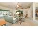 Open living room with neutral tones, carpet floors, a ceiling fan, and an entertainment center, perfect for relaxation at 2132 Nuremberg Blvd, Punta Gorda, FL 33983