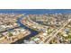 High angle shows the residential neighborhood with waterfront homes along winding canals and ocean access at 2350 W Marion Ave, Punta Gorda, FL 33950