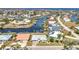 An aerial view showcases a waterfront property with boat dock, lush landscaping and waterway access at 2350 W Marion Ave, Punta Gorda, FL 33950