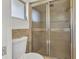 Bathroom featuring a glass door shower, small window, and neutral tile flooring at 2350 W Marion Ave, Punta Gorda, FL 33950