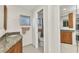 Bathroom with vanity, neutral tile floor, and toilet in a separate room at 2350 W Marion Ave, Punta Gorda, FL 33950