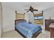 Bright bedroom with blue comforter, wooden furniture, and natural light from two windows at 2350 W Marion Ave, Punta Gorda, FL 33950