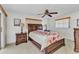 Bedroom with floral bedding, ceiling fan, and matching nightstands at 2350 W Marion Ave, Punta Gorda, FL 33950