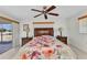 Bedroom with floral bedding, ceiling fan, and matching nightstands at 2350 W Marion Ave, Punta Gorda, FL 33950