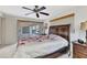 Bedroom featuring a ceiling fan, floral bedding and access to the screened-in porch at 2350 W Marion Ave, Punta Gorda, FL 33950