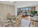 Charming breakfast nook with round glass table and wicker chairs, next to the living room at 2350 W Marion Ave, Punta Gorda, FL 33950
