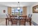 Dining area with a wooden table set, pendant lighting, and natural light from the window at 2350 W Marion Ave, Punta Gorda, FL 33950