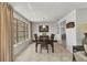 Traditional dining room featuring a wood table set, neutral tile flooring, and natural lighting at 2350 W Marion Ave, Punta Gorda, FL 33950