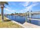 Scenic waterfront view showcasing a private dock with boat lift, set against a backdrop of beautiful homes at 2350 W Marion Ave, Punta Gorda, FL 33950