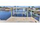 Waterfront property featuring a private dock with a boat lift providing direct access to the canal at 2350 W Marion Ave, Punta Gorda, FL 33950
