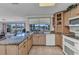 Well-lit kitchen with granite countertops, wooden cabinets, and a view of the waterfront at 2350 W Marion Ave, Punta Gorda, FL 33950