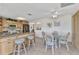 Open kitchen with breakfast bar, granite countertops, stainless steel appliances, and light wood cabinetry at 2350 W Marion Ave, Punta Gorda, FL 33950