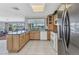 Open concept kitchen featuring stainless steel appliances, granite counters, and a view into the living room at 2350 W Marion Ave, Punta Gorda, FL 33950