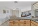 Kitchen with granite countertops, light wood cabinetry, and a breakfast bar that opens to the living room at 2350 W Marion Ave, Punta Gorda, FL 33950