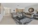 Comfortable living room with stylish furnishings, including sofas, a coffee table, and decor on neutral carpet at 2350 W Marion Ave, Punta Gorda, FL 33950