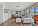 Living room featuring light wood flooring, comfortable seating, and bright natural light at 2350 W Marion Ave, Punta Gorda, FL 33950