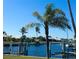 Waterfront canal with boat dock and lush palm trees, ideal for boating enthusiasts at 2350 W Marion Ave, Punta Gorda, FL 33950