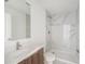 Bathroom features wood cabinets, quartz countertop, marble-look tile shower and floors and modern fixtures at 24259 Peppercorn Rd, Punta Gorda, FL 33955