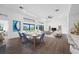 Open-concept dining area featuring modern decor, floor-to-ceiling windows, and a view of the outdoor living space at 24259 Peppercorn Rd, Punta Gorda, FL 33955