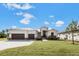 Beautiful home featuring a three car garage, modern design and well-maintained landscaping at 24259 Peppercorn Rd, Punta Gorda, FL 33955