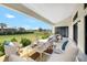 Covered patio with comfortable seating area, with scenic backyard views, and outdoor dining space at 24259 Peppercorn Rd, Punta Gorda, FL 33955