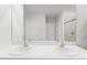 Modern bathroom featuring a double vanity, spacious mirror, and tiled shower at 25336 Deep Creek Blvd, Punta Gorda, FL 33983