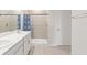 Clean bathroom with a walk-in shower, double sinks and modern tile flooring at 25336 Deep Creek Blvd, Punta Gorda, FL 33983