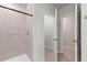 Bright bathroom featuring tiled shower with glass door, linen closet and neutral color palette at 25336 Deep Creek Blvd, Punta Gorda, FL 33983
