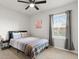 Bright bedroom featuring a ceiling fan, a window with blinds, and a comfortable bed at 25336 Deep Creek Blvd, Punta Gorda, FL 33983