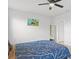 Spacious bedroom features a vibrant blue bed and minimalist decor at 25336 Deep Creek Blvd, Punta Gorda, FL 33983