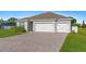 Charming single-story home featuring a spacious three-car garage and well-manicured lawn at 25336 Deep Creek Blvd, Punta Gorda, FL 33983