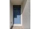 Close-up of a stylish blue front door with decorative panels and modern hardware at 25336 Deep Creek Blvd, Punta Gorda, FL 33983