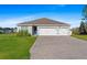 Charming single-story home featuring a spacious three-car garage and well-manicured lawn at 25336 Deep Creek Blvd, Punta Gorda, FL 33983