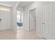 Inviting hallway with light wood floors, white walls and views of the bedroom at 25336 Deep Creek Blvd, Punta Gorda, FL 33983