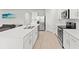 Bright kitchen with stainless steel appliances, white cabinets, and an island with a sink at 25336 Deep Creek Blvd, Punta Gorda, FL 33983