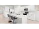 Modern kitchen featuring white cabinets, stainless steel appliances, and a breakfast bar with seating at 25336 Deep Creek Blvd, Punta Gorda, FL 33983