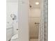 Bathroom featuring white vanity, toilet, mirror and a glass enclosed shower at 2631 Tomaso Rd, North Port, FL 34287