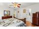 Bedroom with a wooden bed frame, a ceiling fan, and access to the bathroom and hallway at 2631 Tomaso Rd, North Port, FL 34287