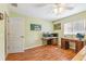 Inviting bedroom with hardwood floors, desk space, and a door leading to another room at 2631 Tomaso Rd, North Port, FL 34287
