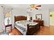 Comfortable bedroom featuring a wooden bed frame, a ceiling fan, and natural light at 2631 Tomaso Rd, North Port, FL 34287