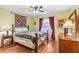Comfortable bedroom featuring a metal bed frame, a ceiling fan, and natural light at 2631 Tomaso Rd, North Port, FL 34287