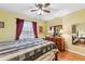 Bedroom with a metal bed frame, a ceiling fan, and natural light at 2631 Tomaso Rd, North Port, FL 34287