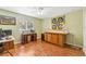 Bright bedroom with hardwood floors, desk space and natural light from a large window at 2631 Tomaso Rd, North Port, FL 34287
