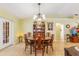 Formal dining room featuring wooden furniture, decorative lighting, and a view of the china cabinet at 2631 Tomaso Rd, North Port, FL 34287